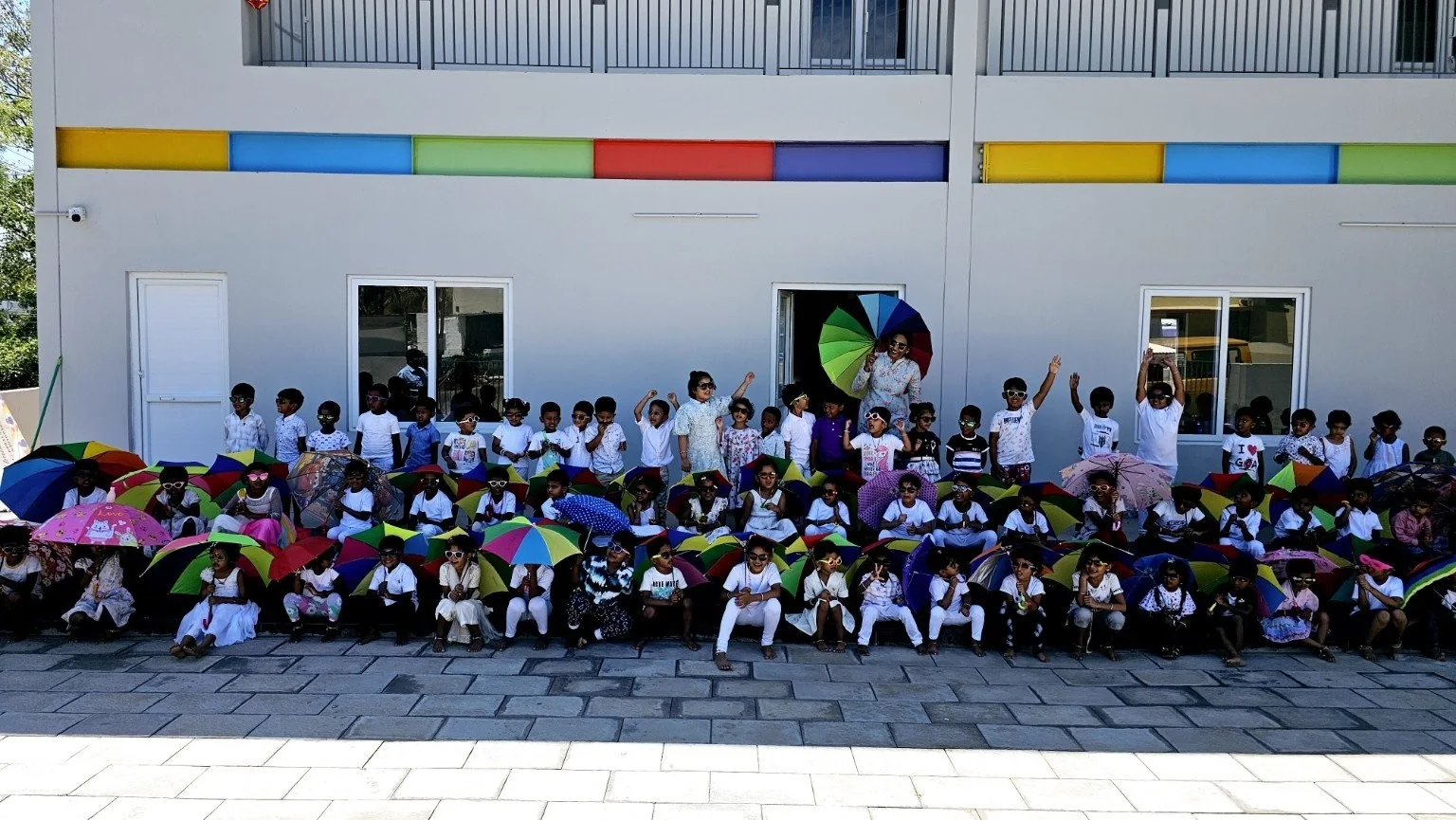 Children participating in a colourful umbrella activity